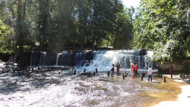 Tourists and locals at the top level of the waterfall at Kulen Mountain in the national park